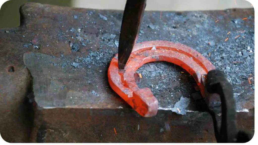 a horseshoe is being hammered into a piece of metal.